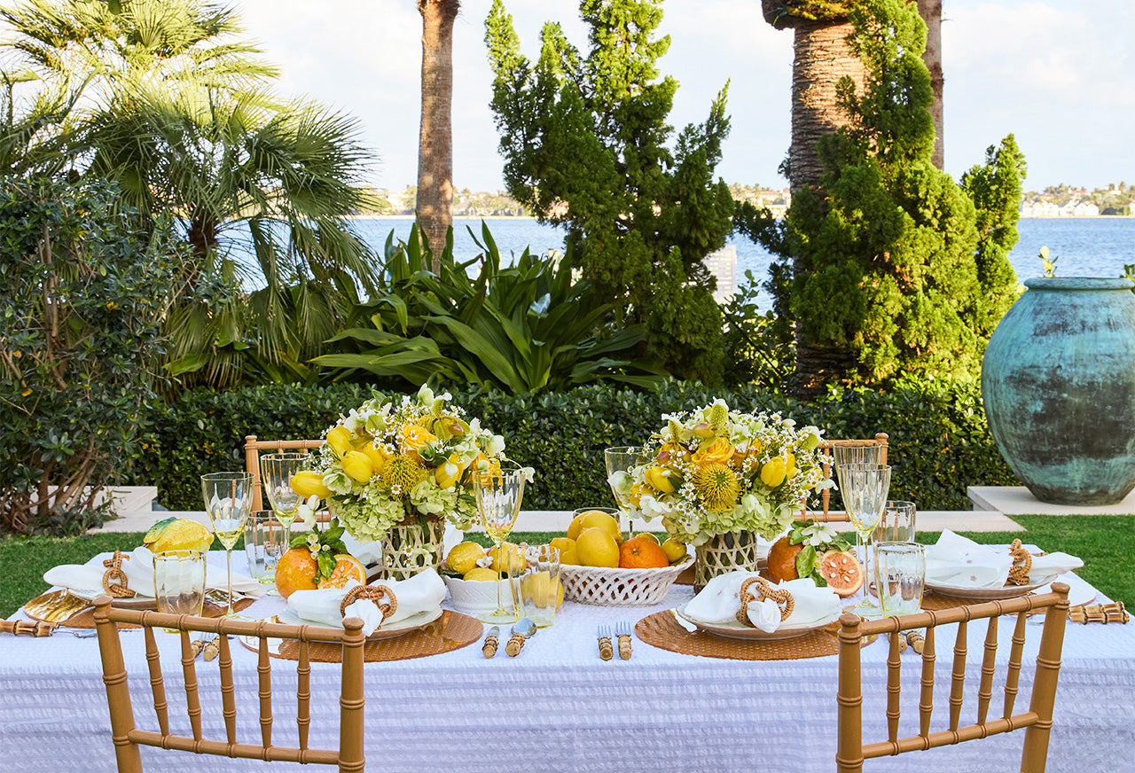 Alfresco dining experience with yellow Italian table decor, citrus centerpiece and designs by Kim Seybert