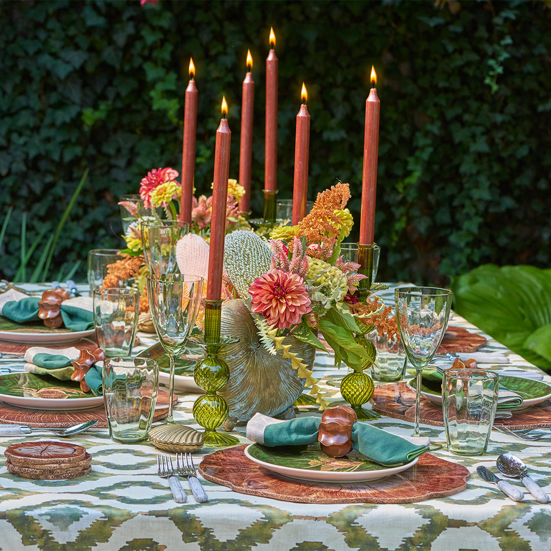 Luxury New England fall tablescape styled outdoors with autumn foliage, layered Kim Seybert table linens, candles, and seasonal decor.