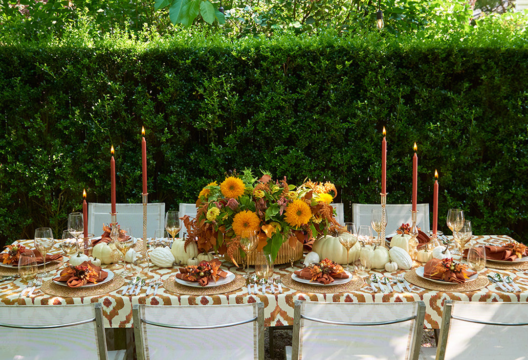 Luxury fall tablescape 2025 outdoors by Kim Seybert with orange harvest decor and beaded placemats