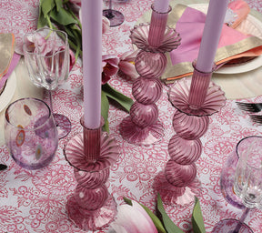 Three lavender Iris Tall Candle Holders on a table with similar-colored tablecloth