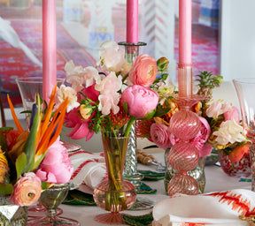 Three blush Iris Tall Candle Holders on a table with pink flowers
