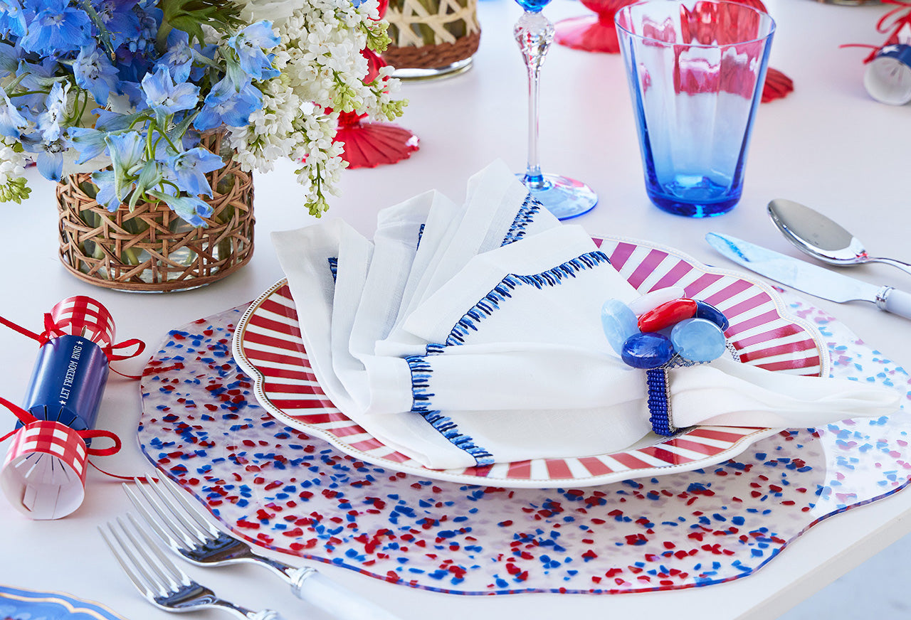 Classic July 4 tablescape with patriotic dinnerware, confetti Sprinkles placemat and seastone napkin ring by Kim Seybert