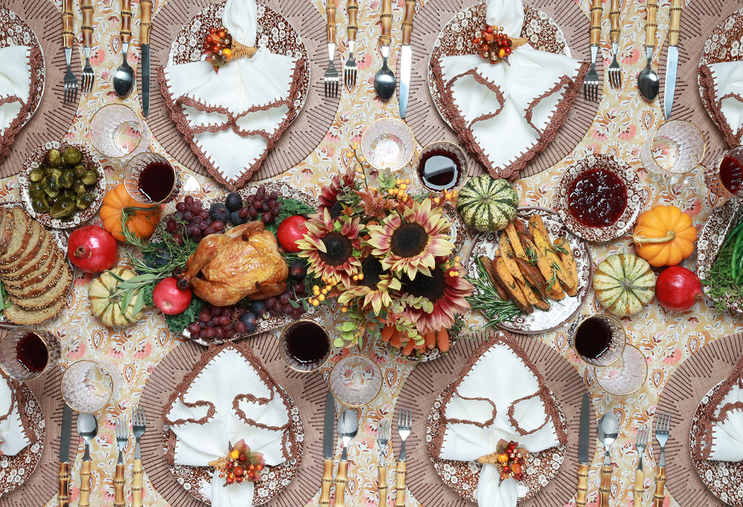 Set of vinyl Thanksgiving placemats styled by Kim Seybert on a fall-themed dining table with candles and autumn accents