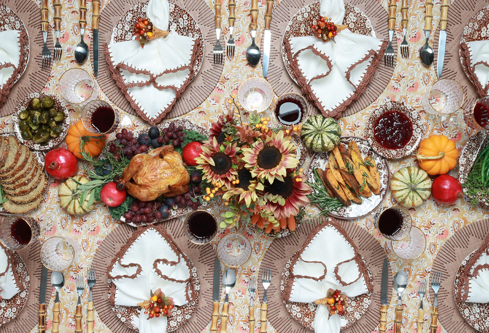 Set of vinyl Thanksgiving placemats styled by Kim Seybert on a fall-themed dining table with candles and autumn accents
