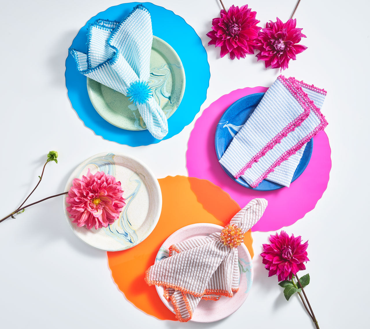 Kim Seybert's Acrylic Pop Placemats in Hot Pink, Orange and Blue are perfect for outdoor dining and entertaining.