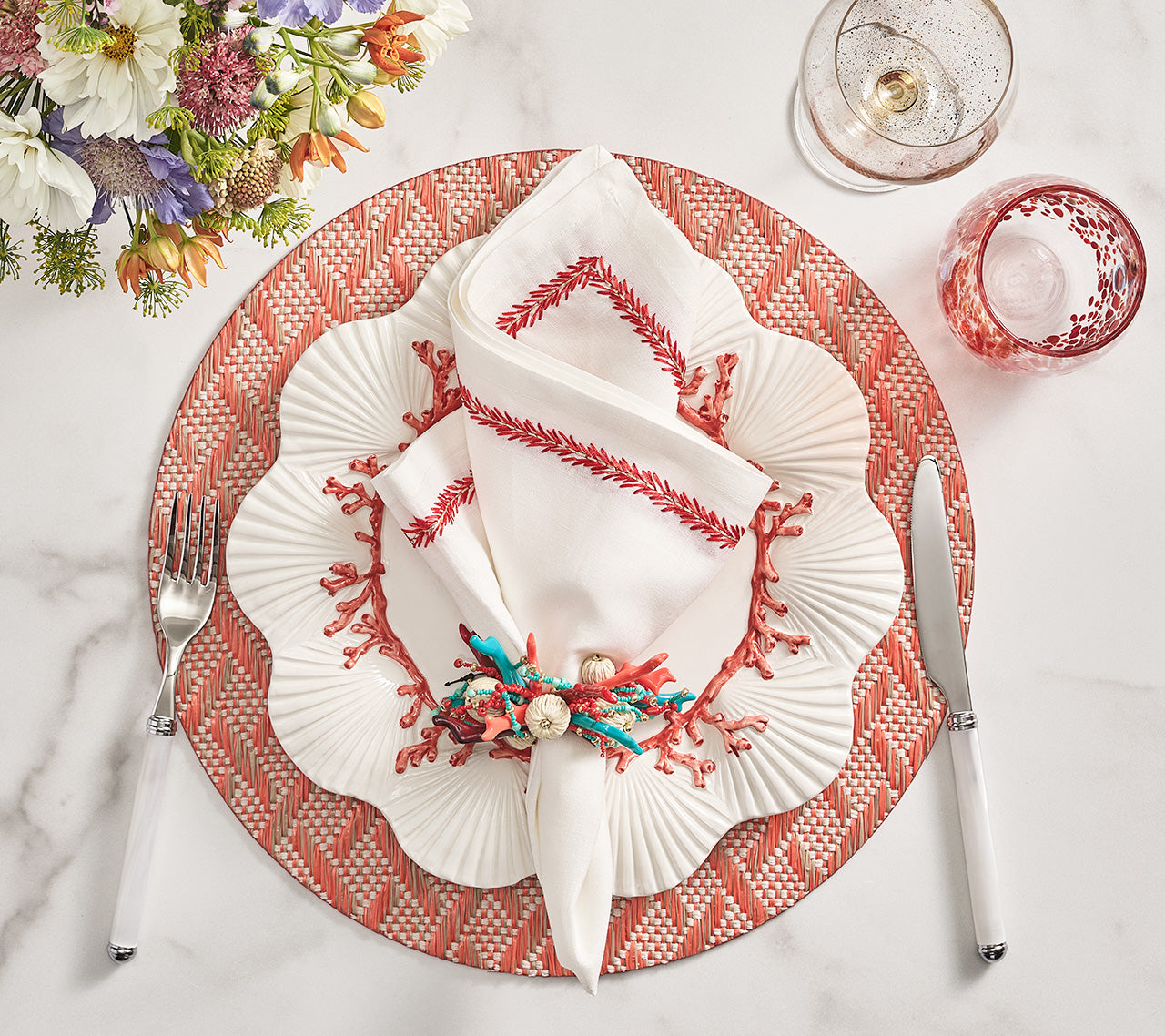 Kim Seybert Luxury Jardin Napkin in White & Coral with basketweave placemat and coral spray napkin ring
