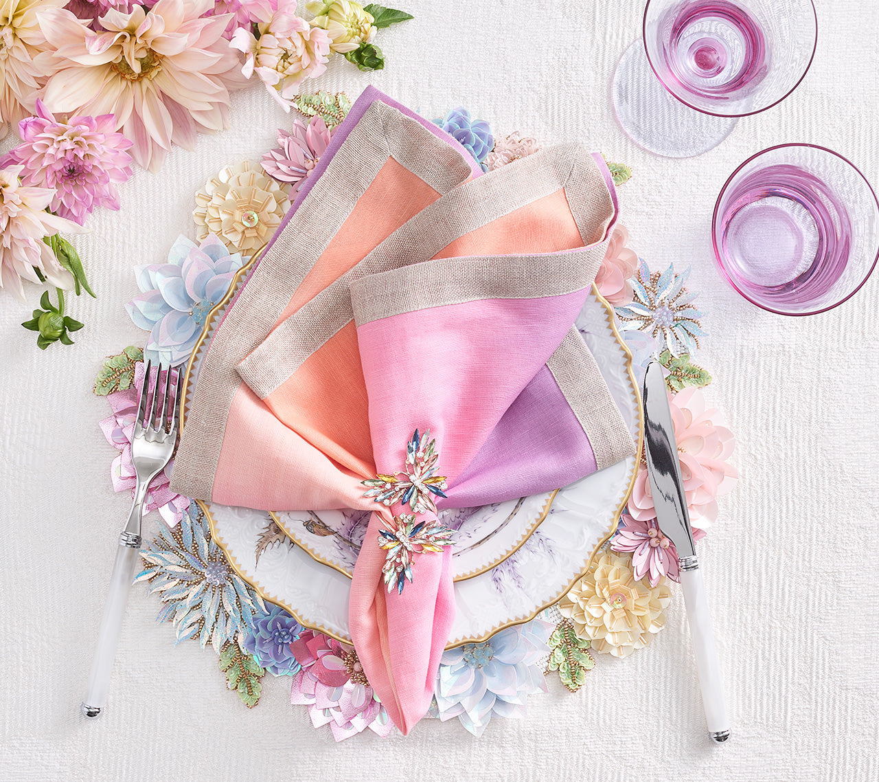 Kim Seybert Luxury Dip Dye Napkin in sorbet on a table setting with a jeweled napkin ring