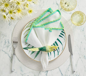 Kim Seybert Luxury Knotted Edge Napkin in White, Marine & Lime with white croco placemat and bird napkin ring