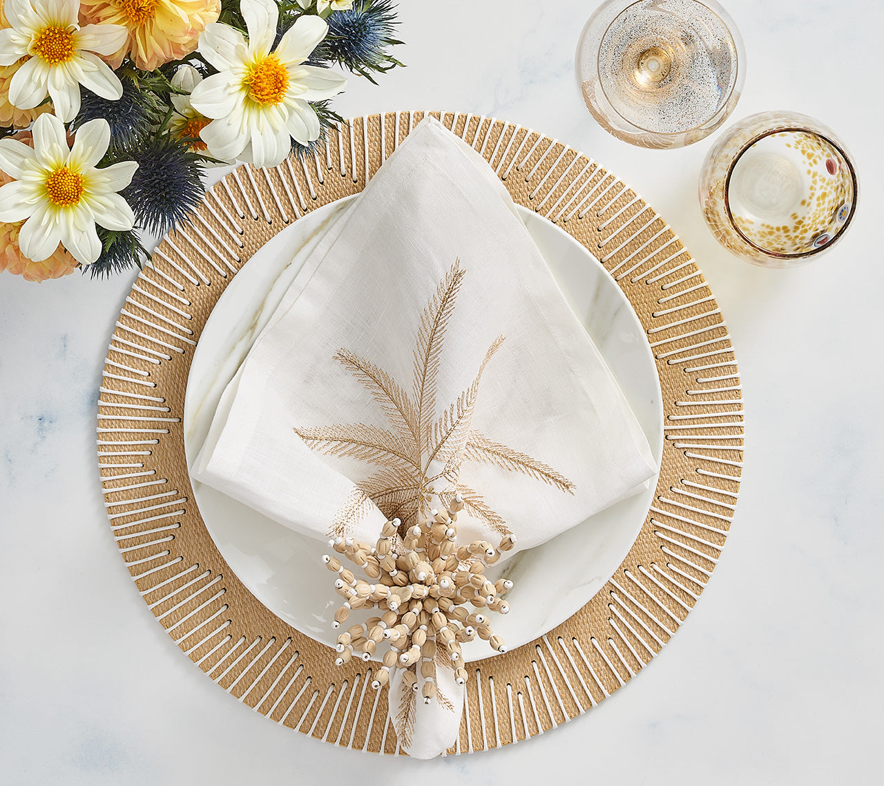 White Palm Coast Napkin with a natural and gold palm frond, folded