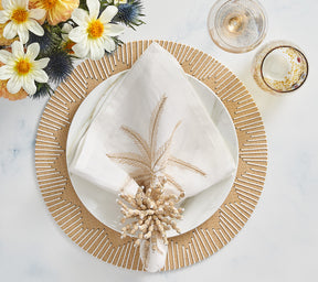 White Palm Coast Napkin with a natural and gold palm frond, folded