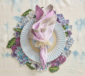 Hydrangea Placemat with white, blue and purple beaded florals underneath a pink napkin