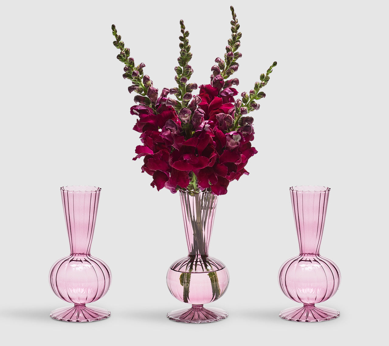 Three Tess Bud Vases in lavender, middle with deep pink flowers