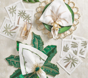 Kim Seybert Luxury Palm Coast Cocktail Napkins on a table with green and gold accents