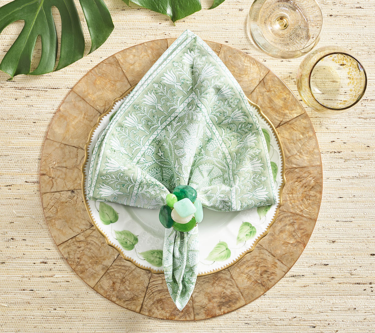 Place setting with a green napkin held by a green Sea Stone Napkin Ring 