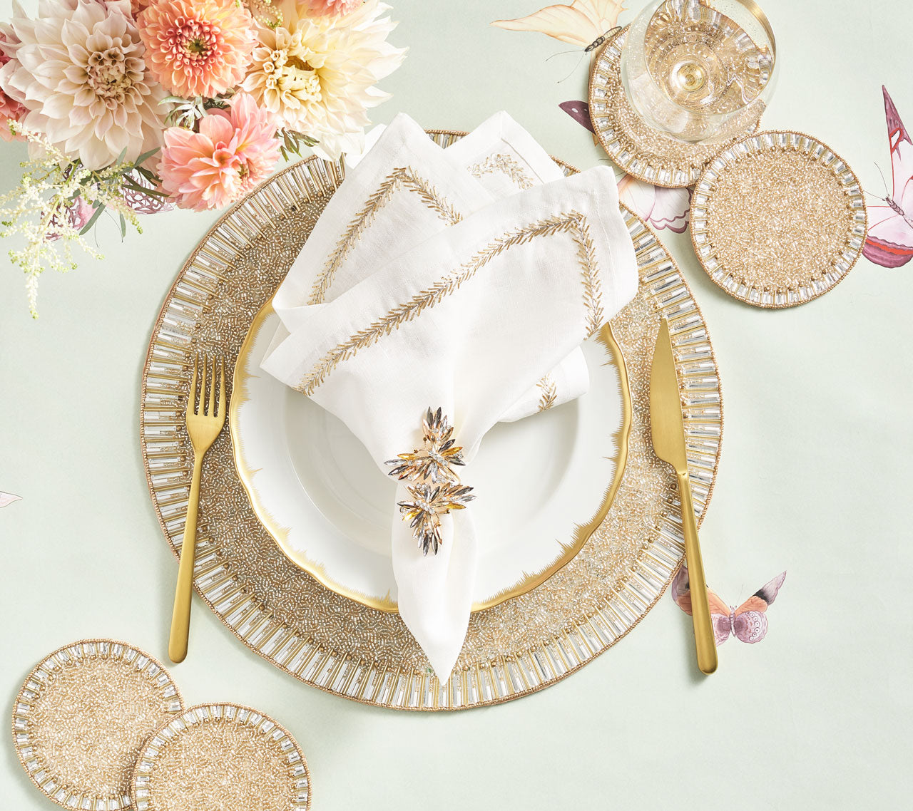 Bevel Drink Coasters next to a place setting with a beaded placemat and gold cutlery