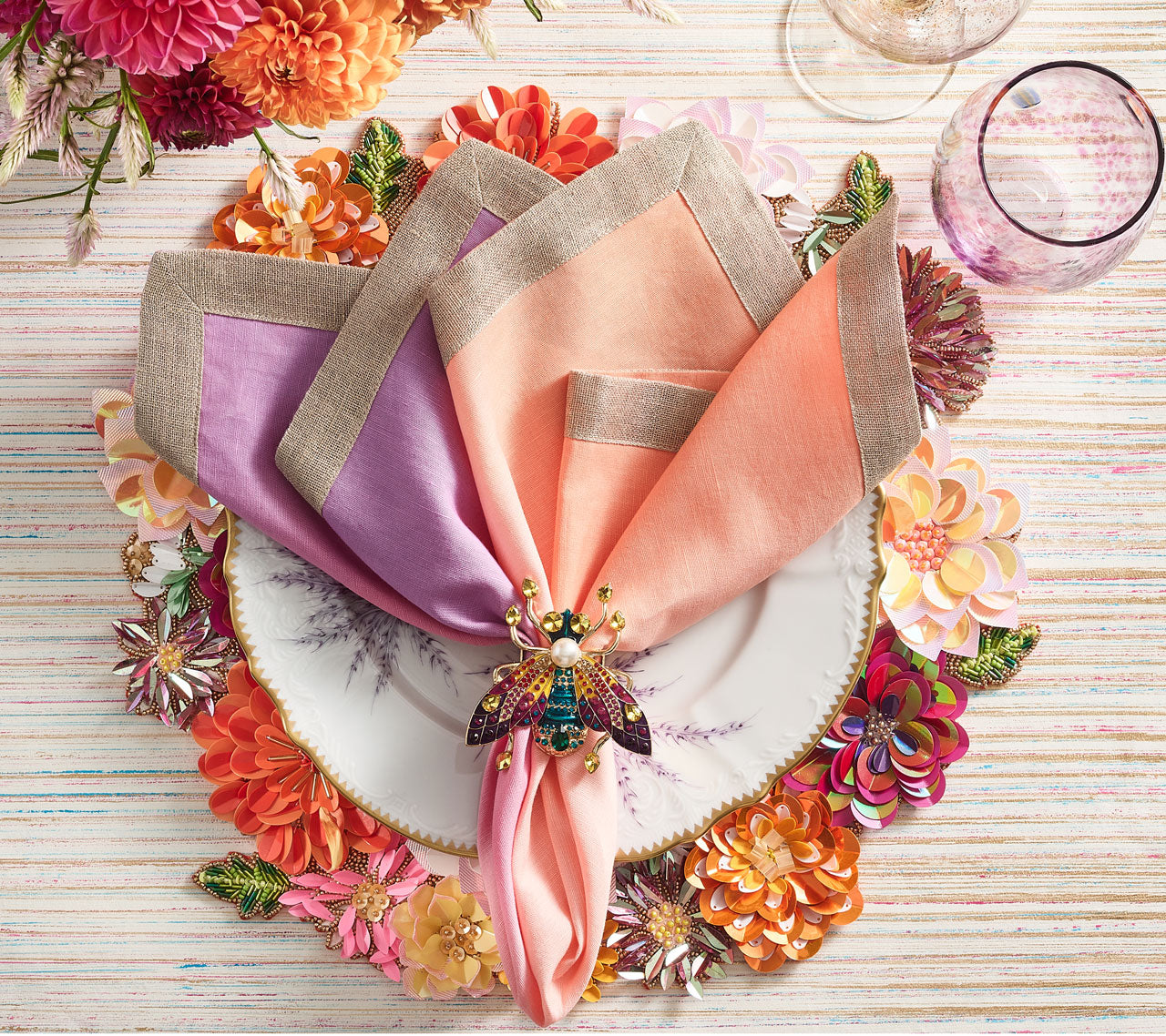 Kim Seybert Luxury Dip Dye Napkin in sorbet on a table setting with a jeweled napkin ring