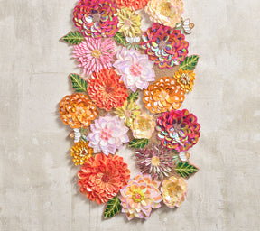 Dahlia Runner in tones of pink, orange and amethyst on a white tablecloth