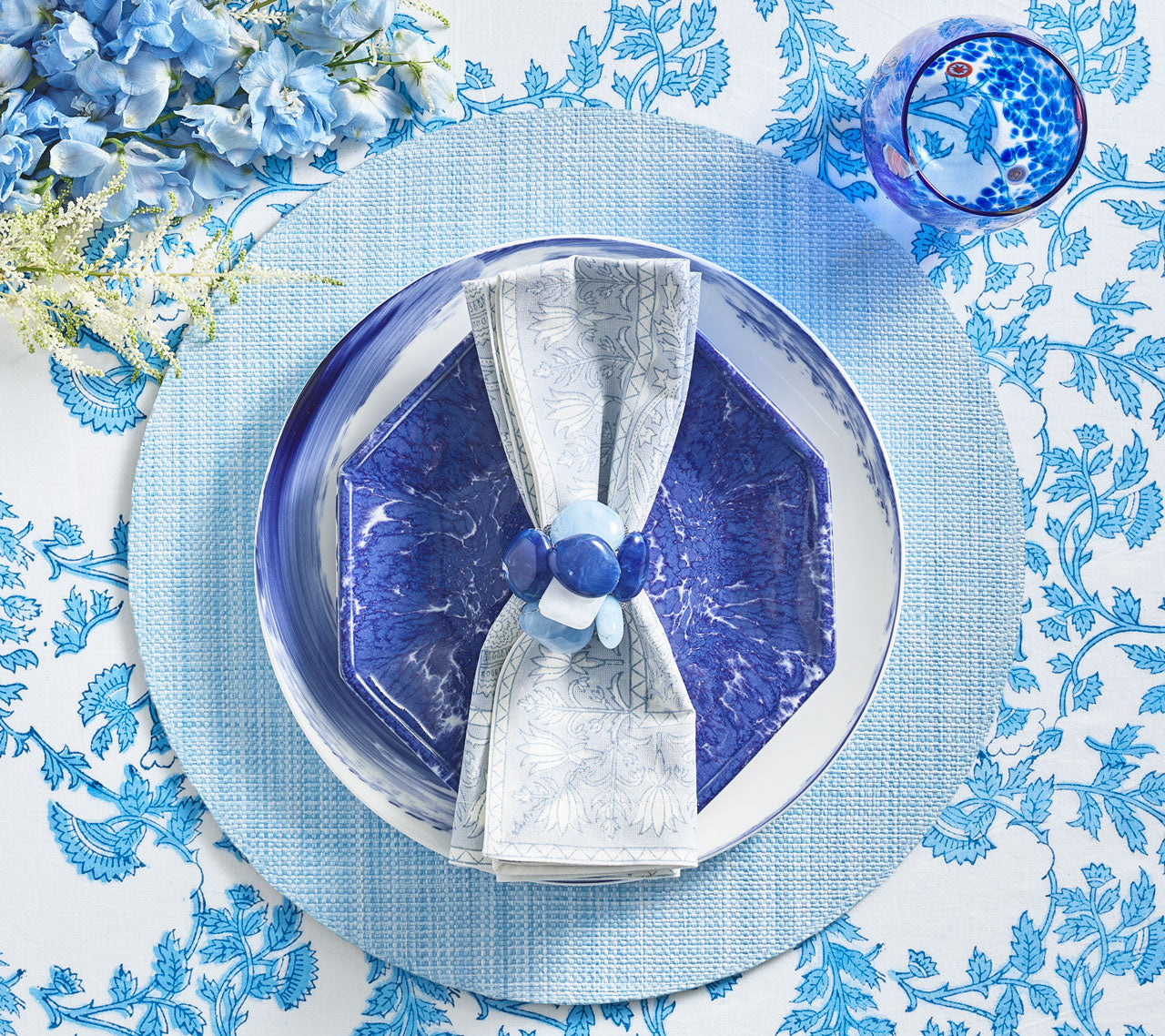 Overhead view of blue place setting featuring aKim Seybert Luxury Provence Napkin in periwinkle