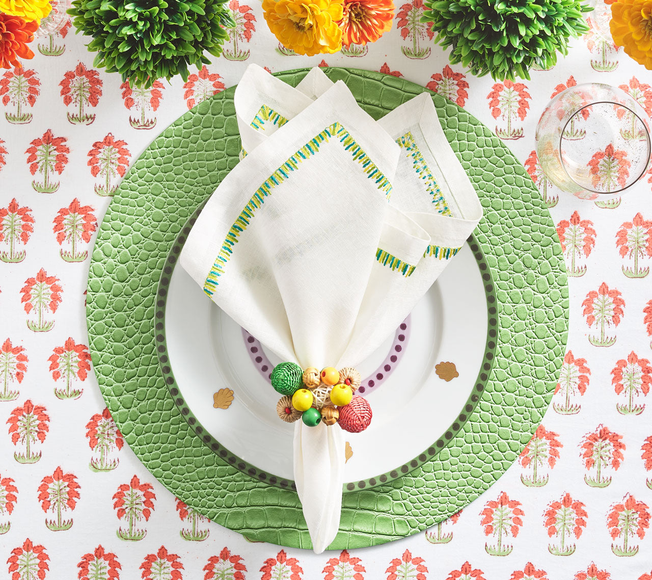 Java Napkin Ring holding a white & green napkin on a green placemat
