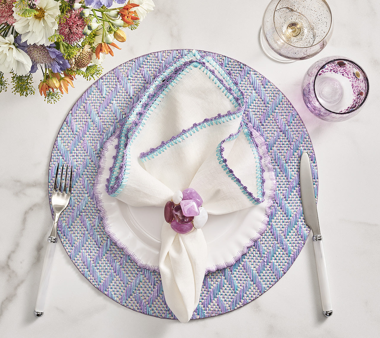 Kim Seybert Luxury Knotted Edge Napkin in White, Lilac & Blue with Herringbone Placemat in Lilac and Seastone Napkin Ring in Lilac