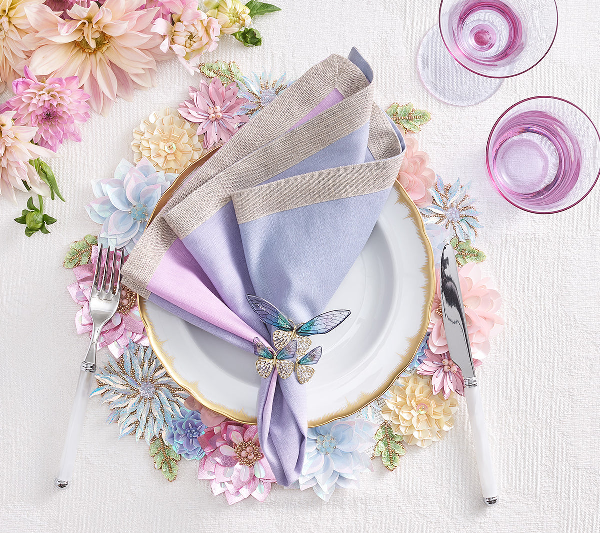 Flutter Napkin Ring holding pastel linen napkins on a table with floral decor
