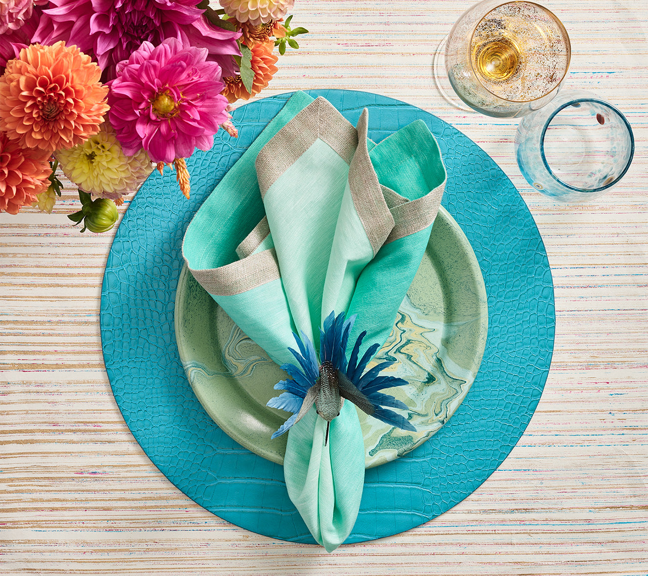 Round Croco Placemat with an embossed faux crocodile pattern in turquoise