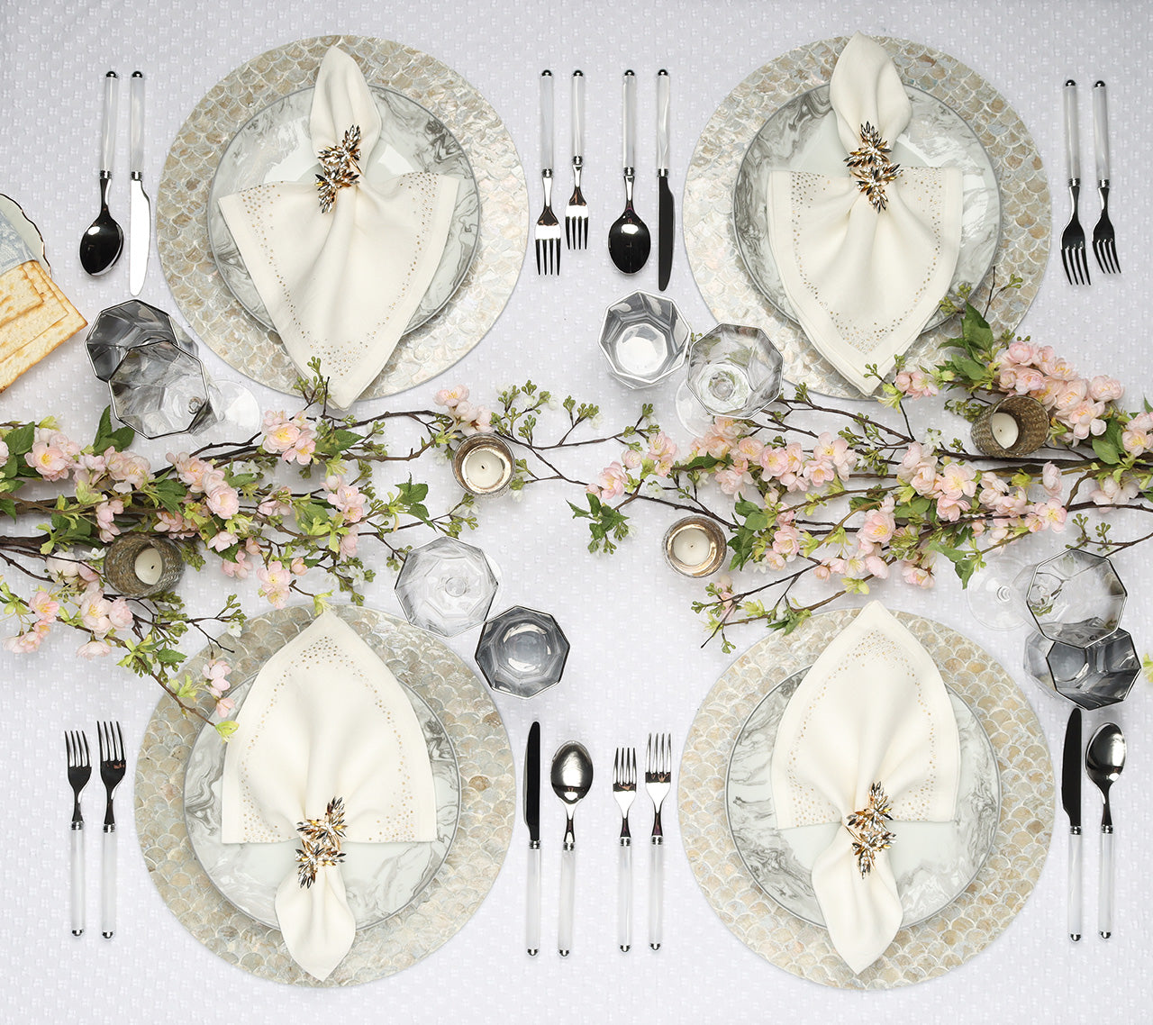 Overhead view of a table with four place setting featuring white Pin Dot Napkins