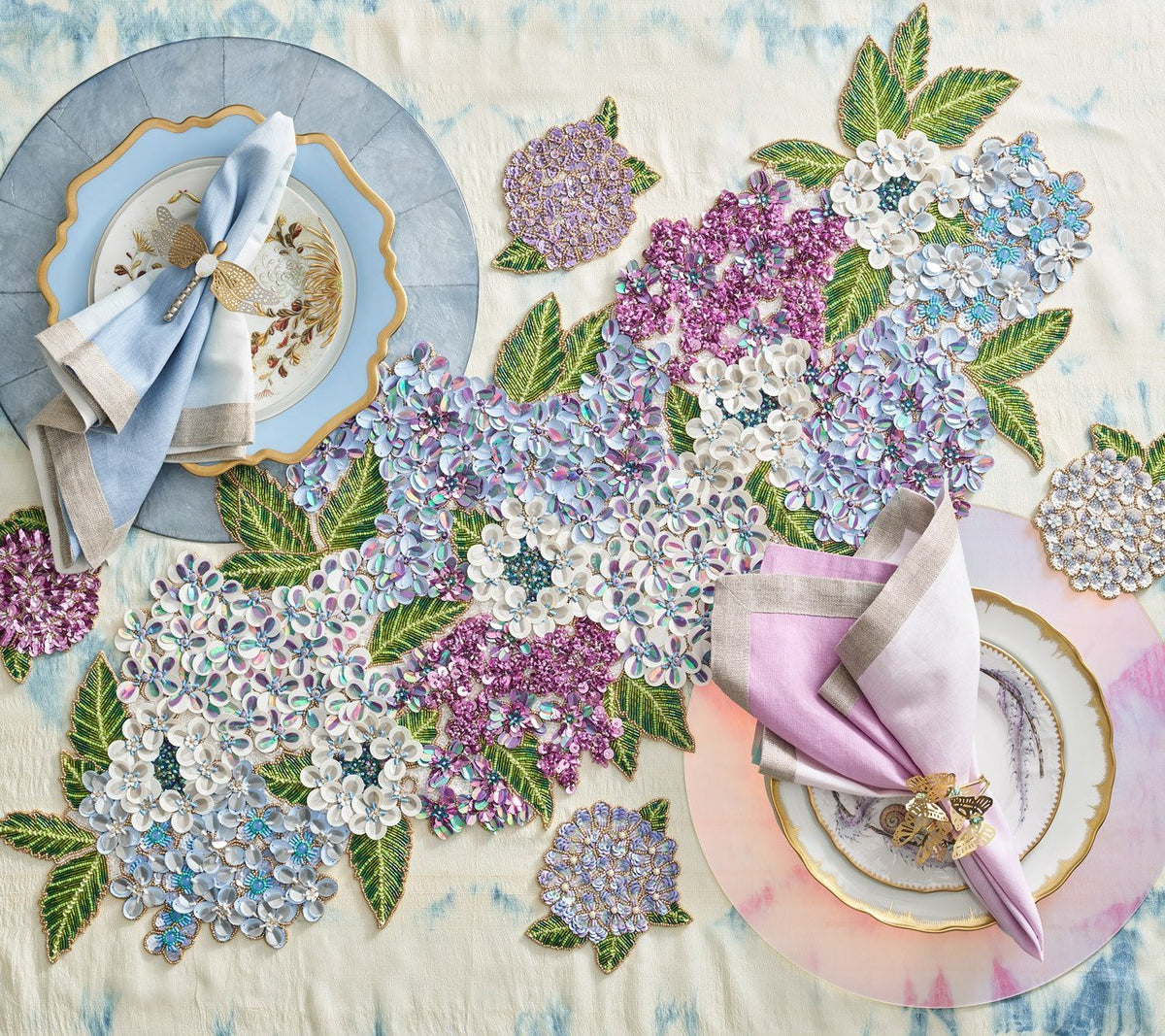 Hydrangea Table Runner in hues of blue, white and purple on a table with similar colored placemats & napkins