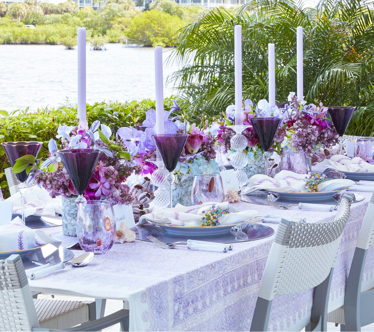 Outdoor table with purple accents and place settings with pastel beaded Spritz Napkin Rings